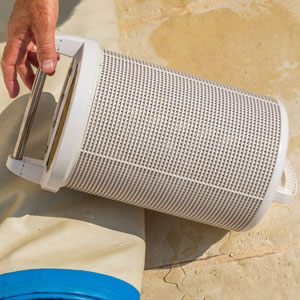 Picture showing pool technician with his hand on a pool basket.